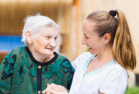 home carer with elderly woman in wheelchair